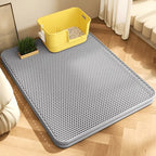 Grey double-layer honeycomb cat litter trapping mat under a yellow litter box