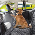 Golden Retriever sitting on black quilted waterproof dog hammock seat cover in car back seat